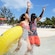 2 Guests holding a water raft splashing in the ocean along Blue Lagoon Island